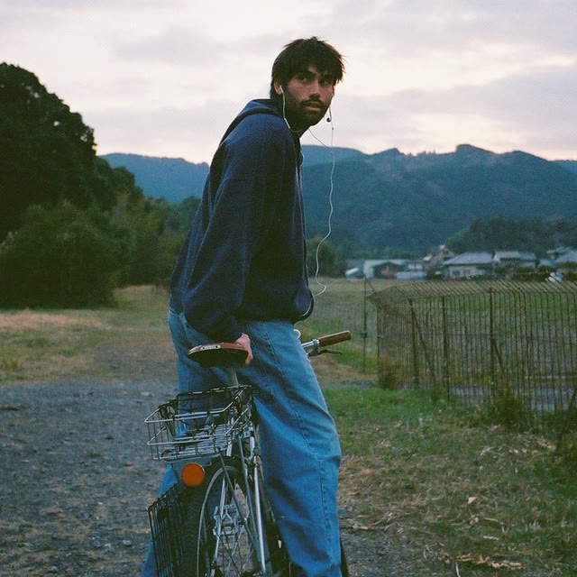 Daniel Avi on a bicycle in the countryside