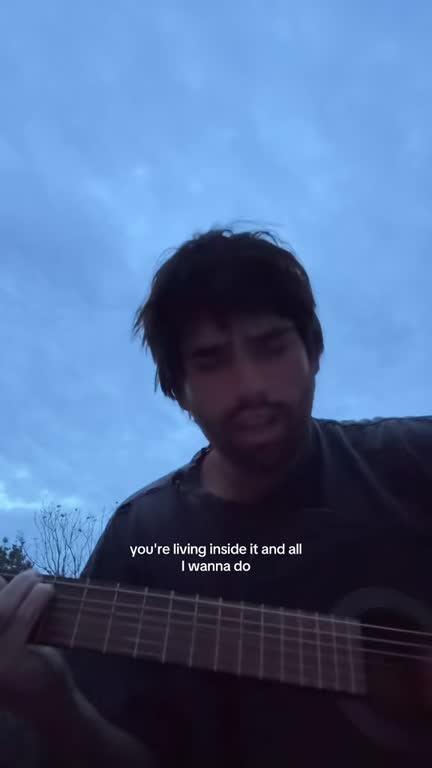 Daniel singing outside under a blue sky